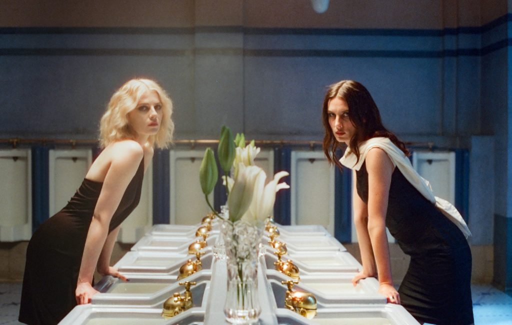 Watch Wolf Alice’s Beautiful New Video For ‘Just Two Girls’ Starring Lucy Boynton: “I’ve Been Trying To Figure Out A Lot Of Things, Like Getting Older”