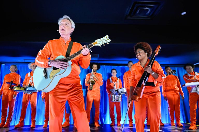David Byrne Brings A Wave Of Orange Tracksuits To Perform ‘What Is The Reason For It?’ On ‘Fallon’